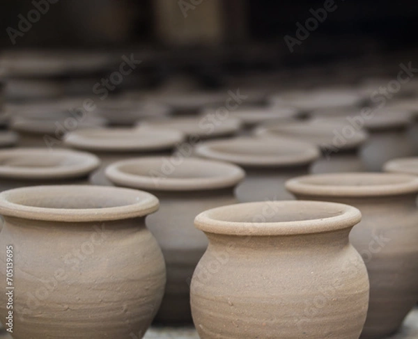 Fototapeta Pottery making involves shaping clay by hand, using a wheel, or coiling techniques.