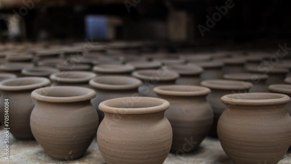 Fototapeta Pottery making involves shaping clay by hand, using a wheel, or coiling techniques.