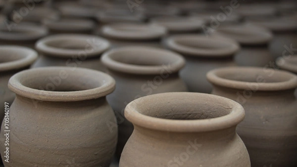 Fototapeta Pottery making involves shaping clay by hand, using a wheel, or coiling techniques.