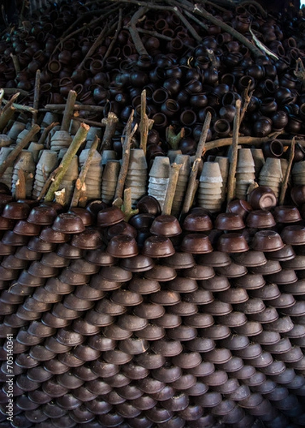 Fototapeta Pottery making involves shaping clay by hand, using a wheel, or coiling techniques.