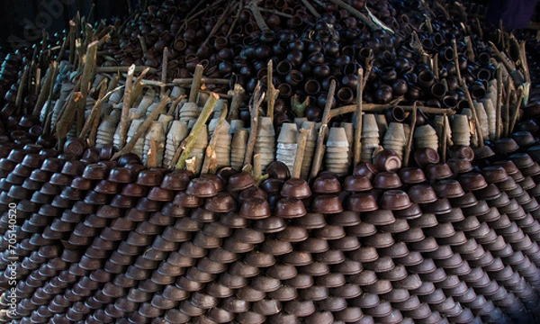 Fototapeta Pottery making involves shaping clay by hand, using a wheel, or coiling techniques.