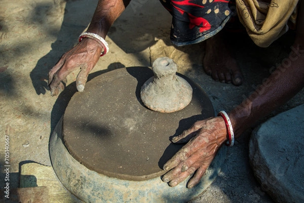 Fototapeta Pottery making involves shaping clay by hand, using a wheel, or coiling techniques.