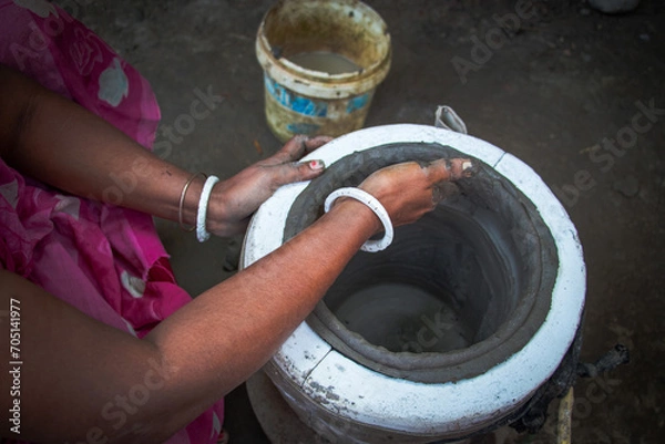 Fototapeta Pottery making involves shaping clay by hand, using a wheel, or coiling techniques.