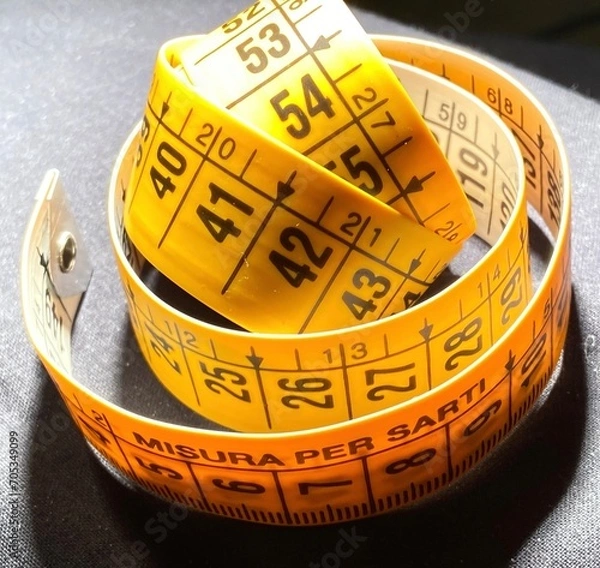 Obraz Centimeterized plastic strip for tailors and fashion workshops. Tape measure for domestic and professional sewing projects. Neutral and light or dark background.