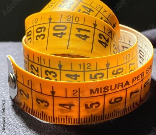 Obraz Centimeterized plastic strip for tailors and fashion workshops. Tape measure for domestic and professional sewing projects. Neutral and light or dark background.