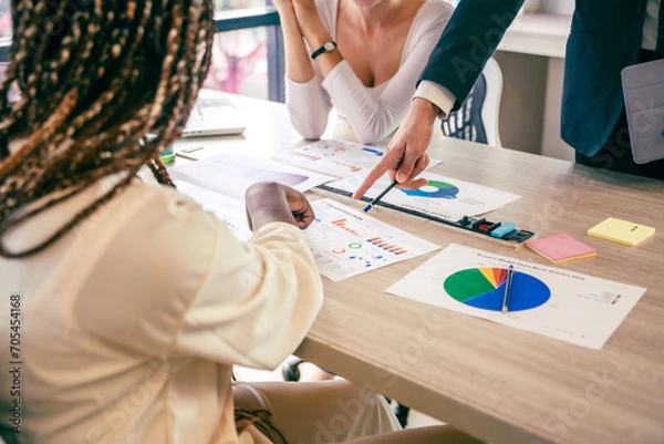 Fototapeta Business analyst team using laptop for financial insight with Fintech paper for data analysis dashboard. Creative and analytic brainstorming for marketing plan strategy system idea. Prodigy teamwork