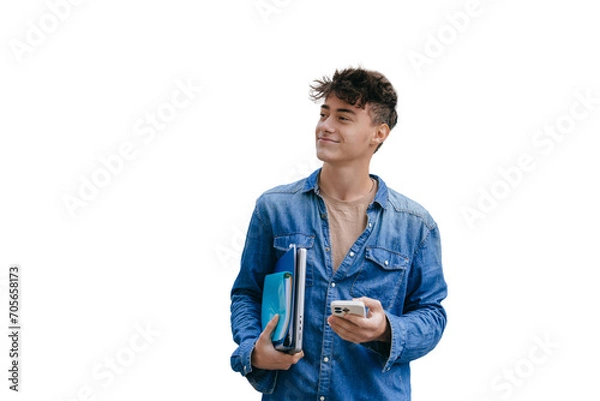 Fototapeta Satisfied guy in jeans shirt holding notebook, folders and phone looks aside standing against transparent background, passed exam. Smart teen boy goes to university. Education