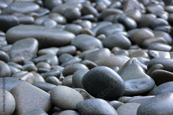 Fototapeta An abstract background of pebbles on the beach. Rocks texture and pattern with copy space for additional text.