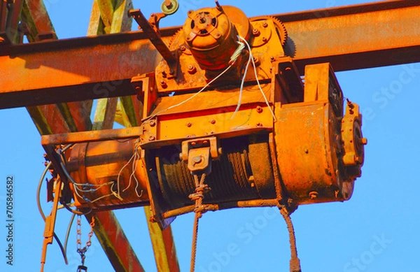 Fototapeta Lifting motor gear of a rusty, abandoned industrial crane structure