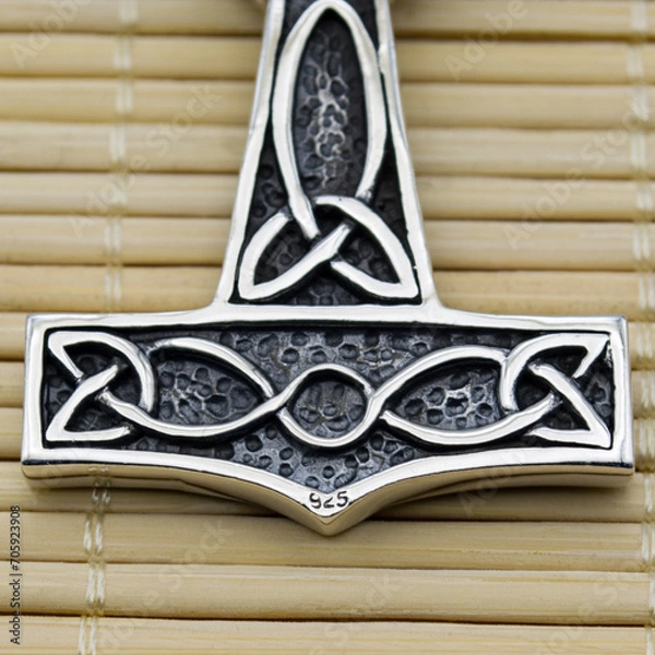 Fototapeta Silver Mjolnir pendant. Peruns ax. Pagan Style. Ancient amulet of Vikings and Slavs. A symbol of strength and power. Protection from evil spirits. Skull, ram's head. Kolovrat. Asatru.