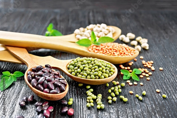 Obraz Lentils with chickpeas and beans in spoons on board