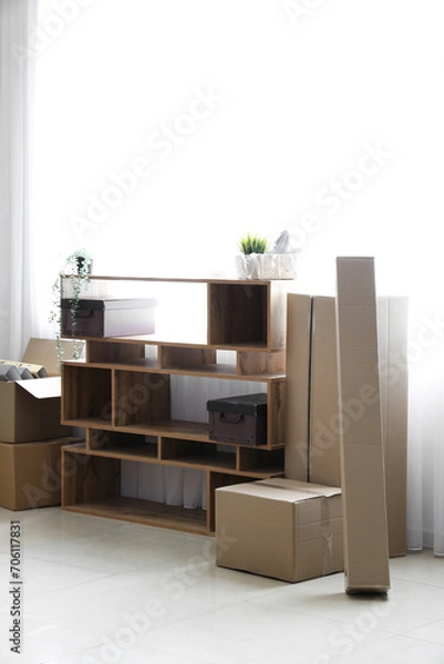 Fototapeta Shelving unit with cardboard boxes in office on moving day