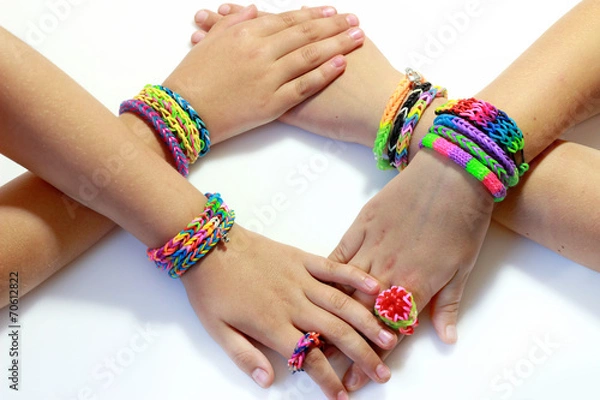Obraz Elastic and colorful rainbow loom bracelet on hands