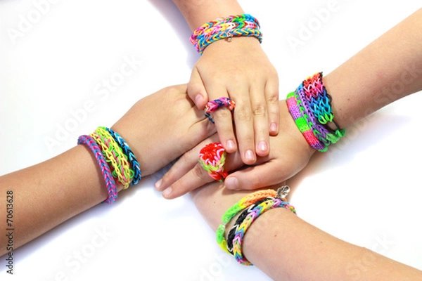 Obraz Elastic and colorful rainbow loom bracelet on hands