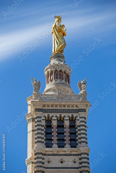 Fototapeta Golden blessed Mary with Jesus child on top of the tower of Cathedral of Notre-Dame de la Garde in Marseille, France