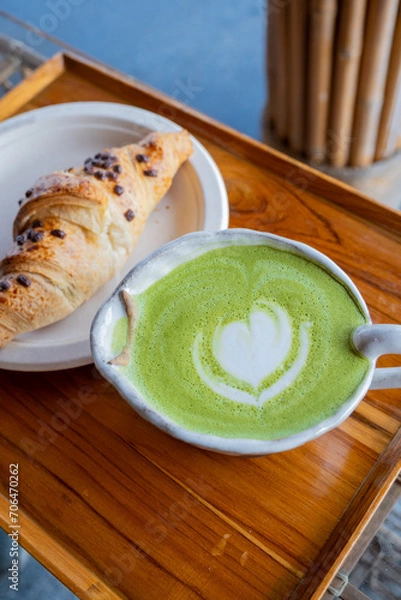 Obraz Close-up photo of green tea latte art paired with croissants