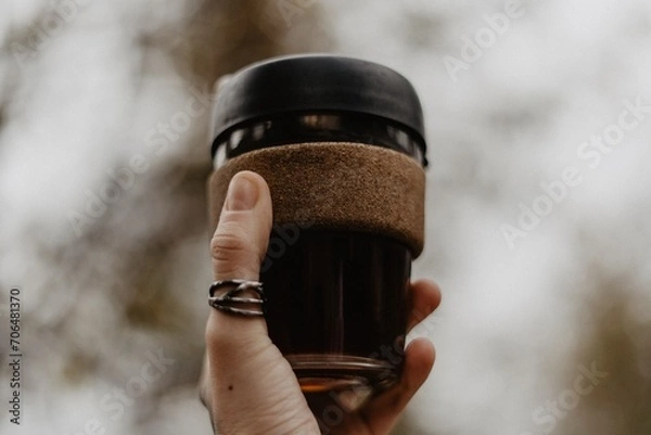 Obraz hand holding a bottle