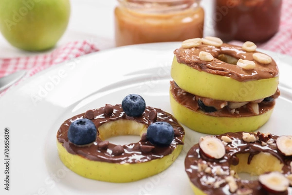 Obraz Fresh apples with nut butters, blueberries and nuts on plate, closeup