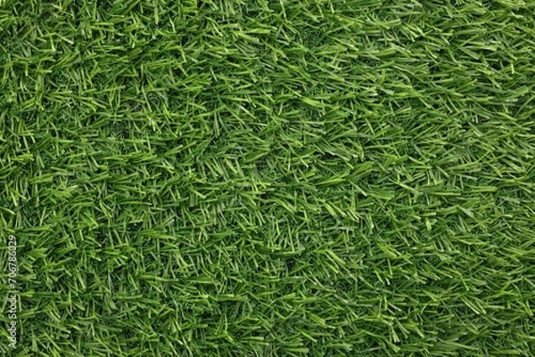 Fototapeta Green artificial grass as background, top view