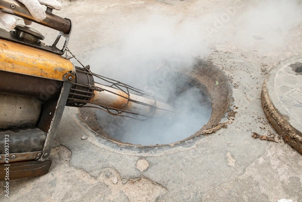 Fototapeta fumigating the sewer at horizontal composition