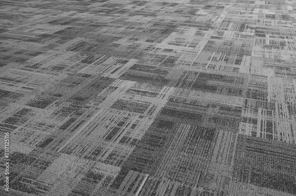 Fototapeta Defocus on the seamless abstract pattern of the airport carpet floor ,made of velvet and its black and white tone