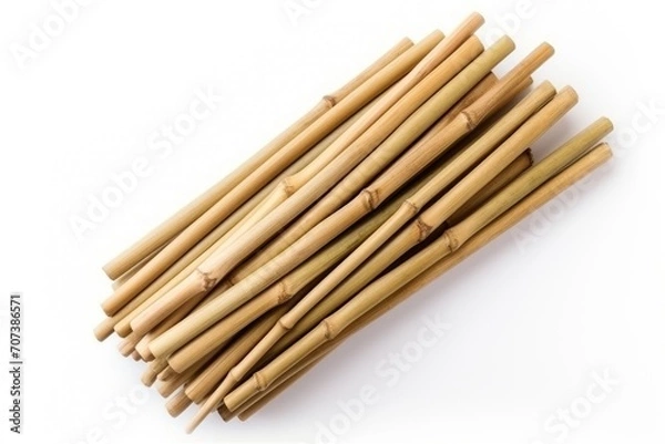 Fototapeta Dry bamboo sticks arranged on white surface from a top perspective
