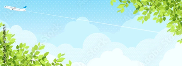 Obraz 新緑と青空の中を飛ぶ飛行機　背景素材（バナー向け横長）