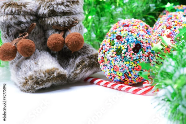 Obraz Green tinsel with snow boots decoration