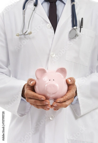 Fototapeta Doctor, man and piggy bank for savings in studio, investment and financial loan for healthcare. Male professional, funding and planning hospital budget by white background, profit and future security