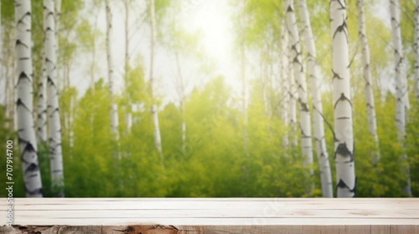 Fototapeta Empty wooden table top for displaying products against birch trees grove blurred in summer
