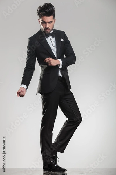 Fototapeta elegant handsome man snapping his fingers