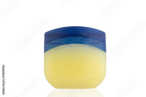 Fototapeta Vaseline Bottle on a white background. 
Jar for petroleum jelly. 
Yellow plastic container with blue lid.
