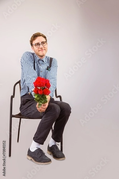 Fototapeta Geeky hipster holding a bunch of roses