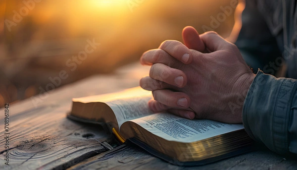 Obraz hands pray to God with the bible