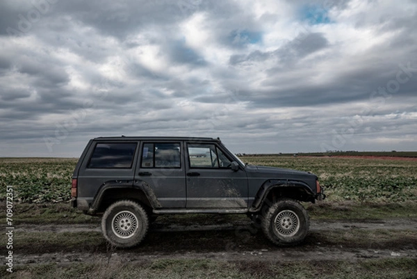 Obraz Classic offroad SUV car on the dirt road