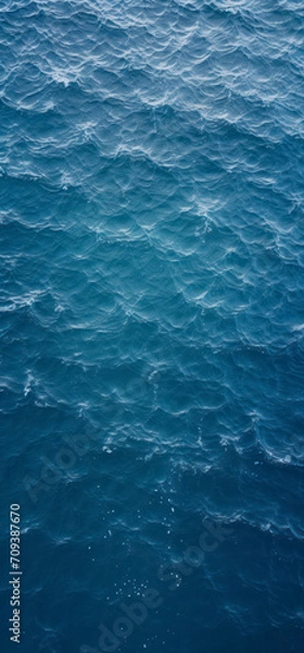 Fototapeta Top view of blue frothy sea surface. Shot in the open sea from above.