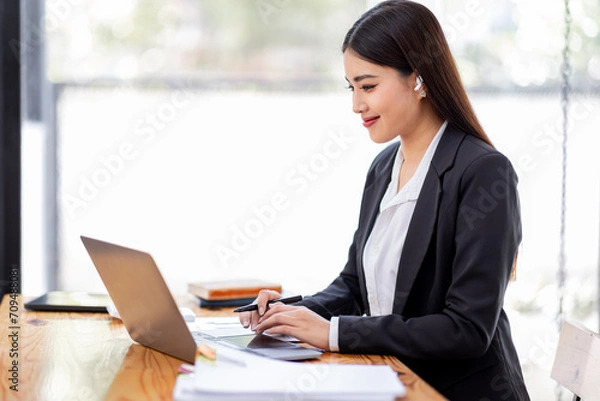 Fototapeta Asian businessman hand using calculator and working with laptop calculate about finance accounting at workplace.finance accounting concept