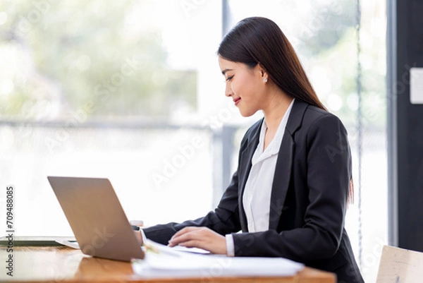 Fototapeta Asian businessman hand using calculator and working with laptop calculate about finance accounting at workplace.finance accounting concept