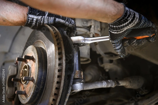 Fototapeta car brake system repair with shallow depth of field