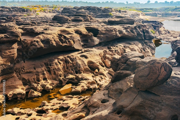 Fototapeta Grand Canyon in Thailand, Nature of rock canyon in Mekong River, Dry rock reef in the Mekong River with mountain hills. View of Sam Phan Bok is called Valley of Thailand. Nature landscape background.