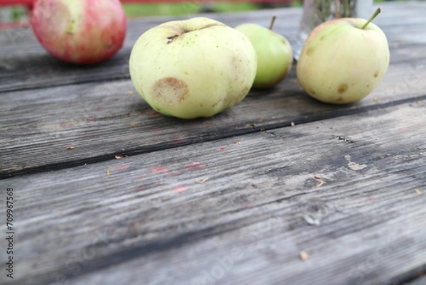 Fototapeta apples on a table in the countryside in summer