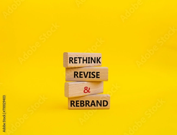 Fototapeta Rethink Revise and Rebrand symbol. Wooden blocks with words Rethink Revise and Rebrand. Beautiful yellow background. Business and Rethink Revise and Rebrand concept. Copy space.