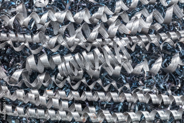Fototapeta Metal spiral shavings after working on a lathe. Angled view. Background for design.