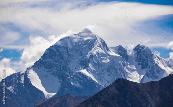 Fototapeta High mountain peak with steep slopes, cliffs, glaciers in the Tien Shan in autumn.