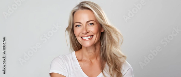 Obraz Beautiful middle-aged woman on a gray background.