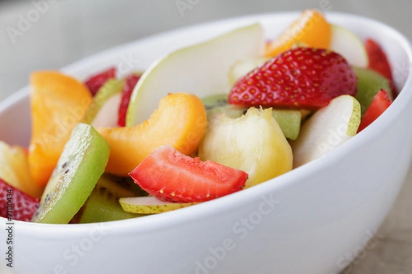 Fototapeta fresh mix fruit salad with strawberry, kiwi and peach