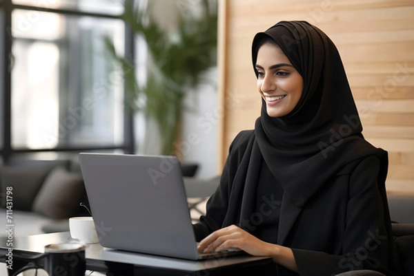Obraz a hijab woman working with her laptop
