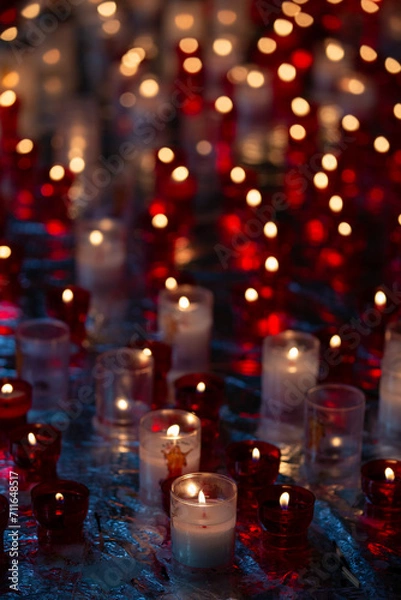 Fototapeta Small candles in a glass at the church, shallow depth of field (DOF)