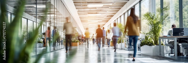 Fototapeta Businesspeople walking at modern office. Concept work process. Business workplace with people in walking in blurred motion in modern office space.