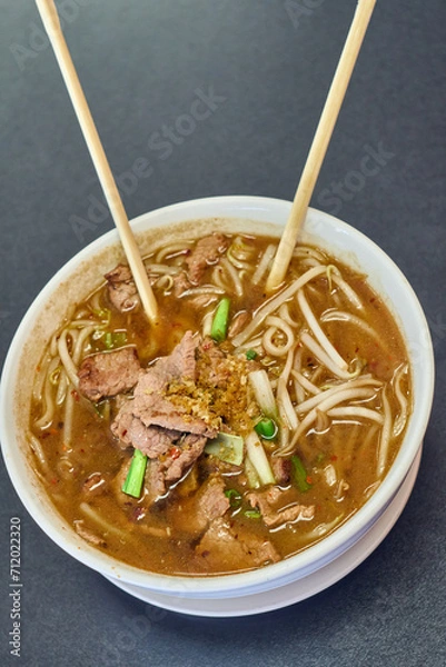 Obraz Vietnamese Rice Noodles Soup with Vietnamese Sausage served vegetables and crispy onion - Asian food style